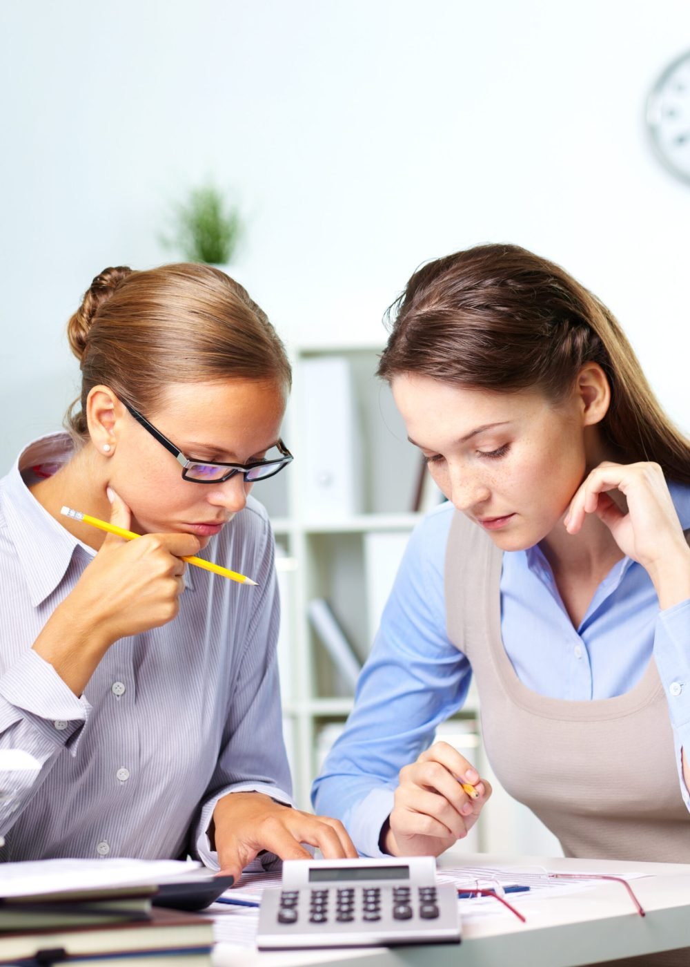 Portrait of two businesswomen working with papers in office